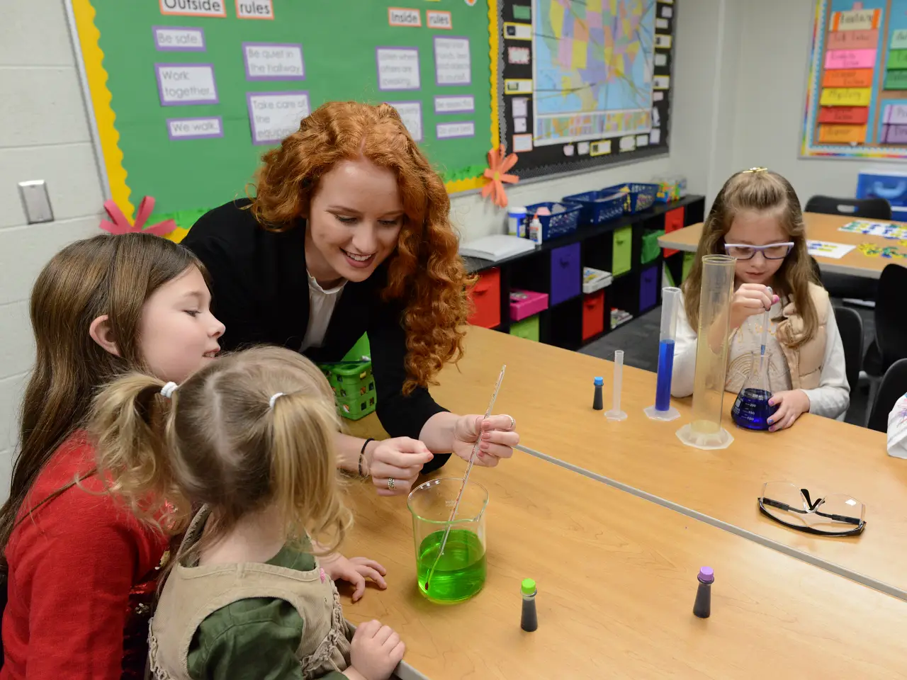 student teacher working with elementary students